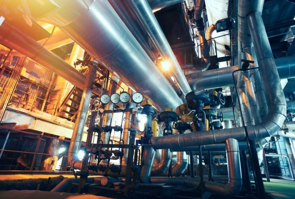 Equipment, cables and piping as found inside of a modern industrial power plant